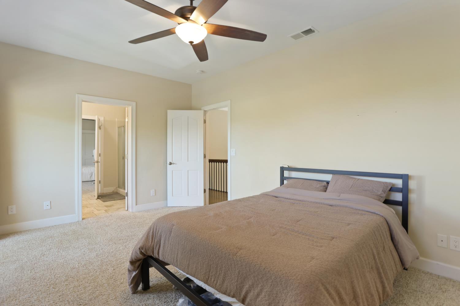 9935 Hazel Road Stockton, CA 95212 - Photo 52 of 98 a bed room with a bed and a ceiling fan