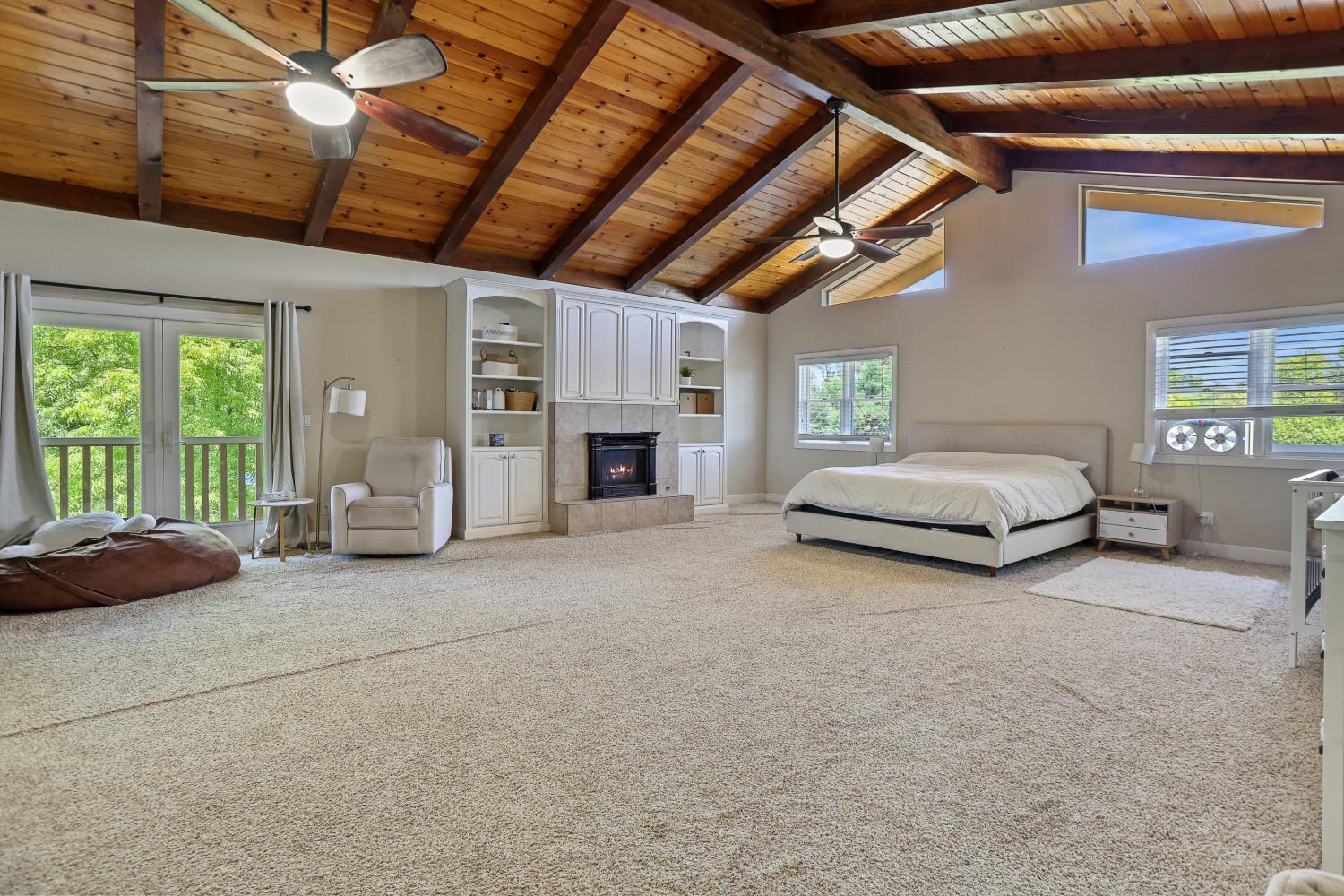 9935 Hazel Road Stockton, CA 95212 - Photo 57 of 98 a spacious bedroom with a bed and a chandelier