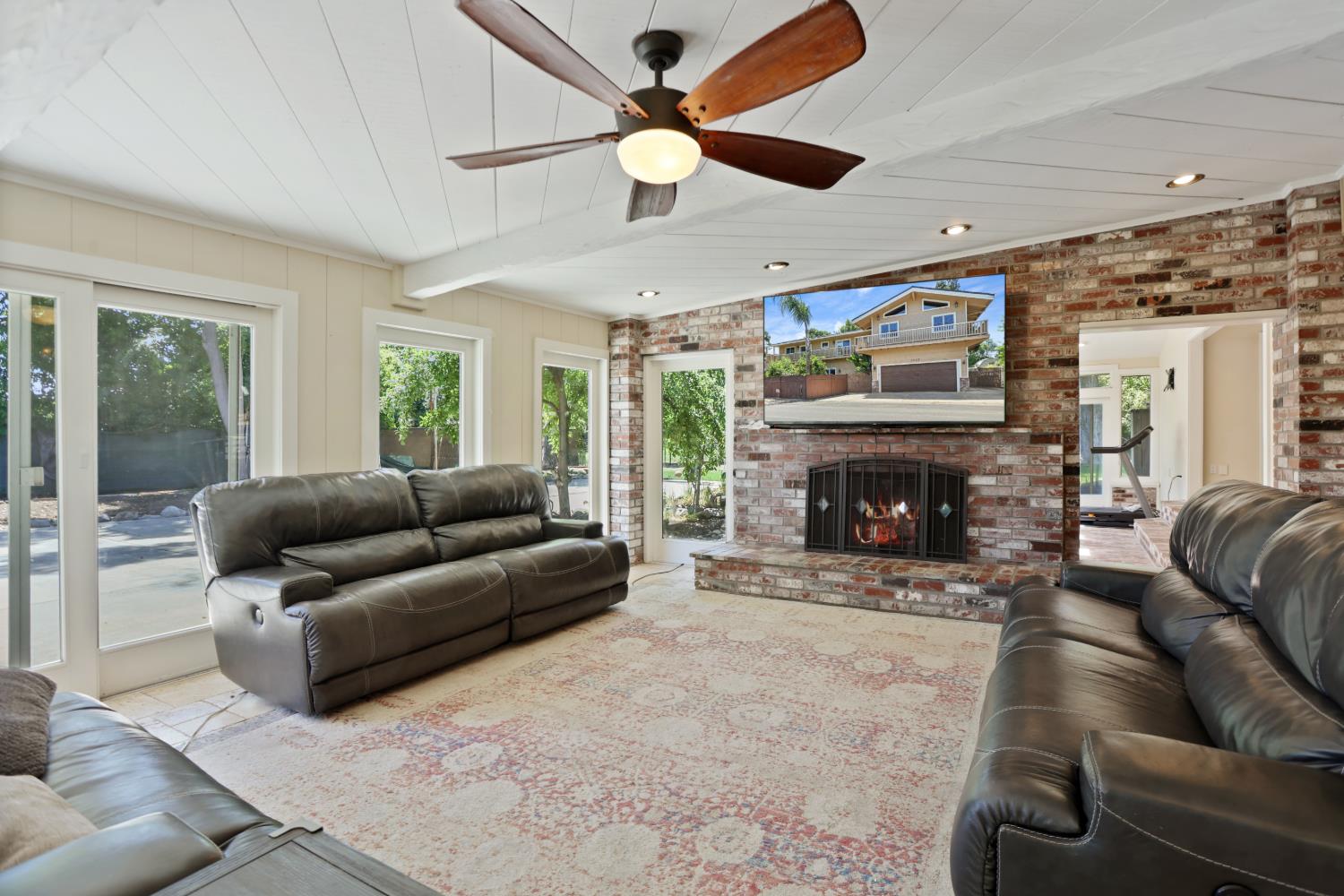 9935 Hazel Road Stockton, CA 95212 - Photo 6 of 98 a living room with furniture a large window and a fireplace