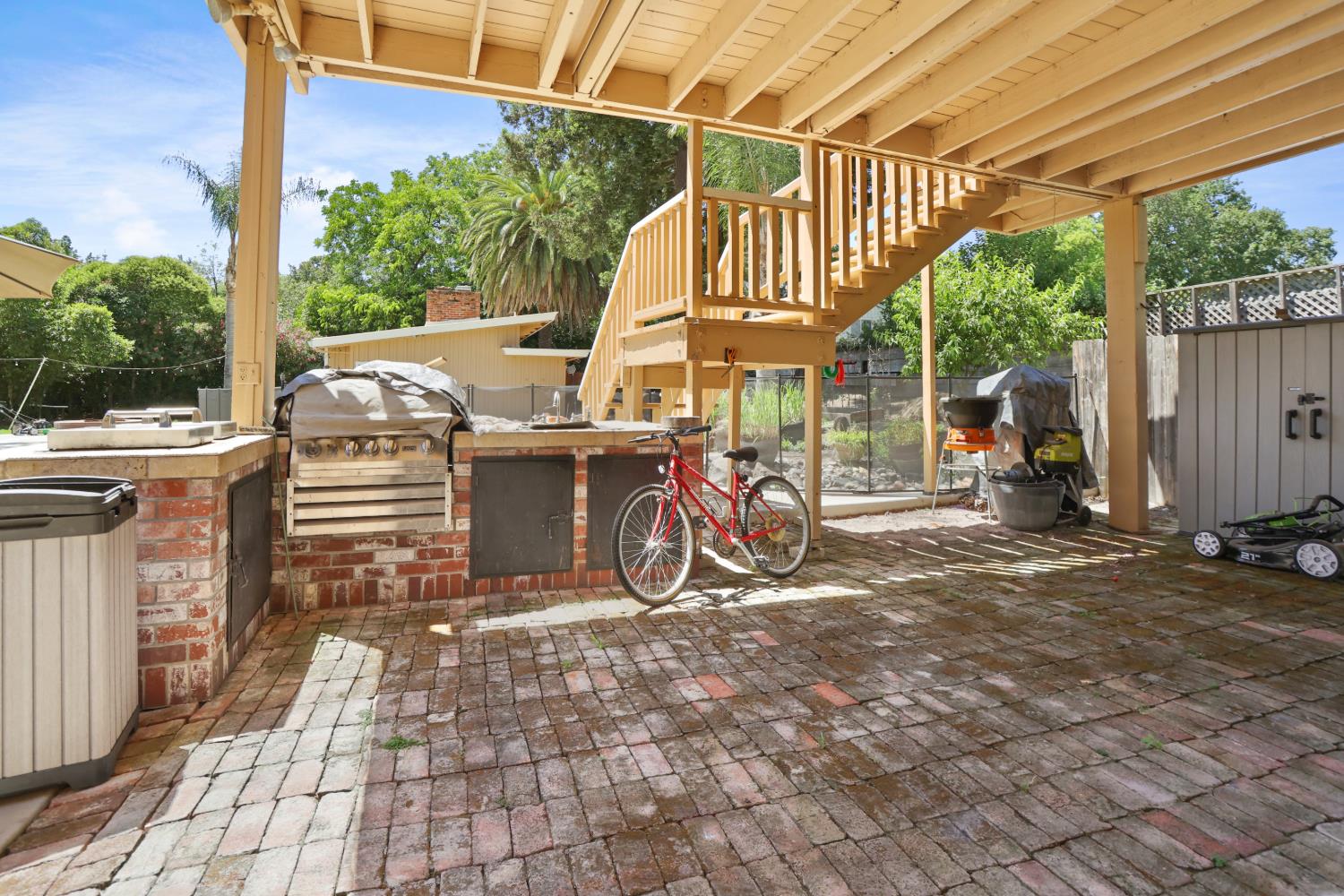 9935 Hazel Road Stockton, CA 95212 - Photo 80 of 98 a view of a patio with table and chairs under an umbrella