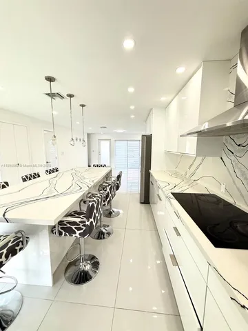 a kitchen with stainless steel appliances kitchen island granite countertop a sink and cabinets