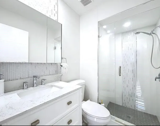 a front view of a house with outdoor space and lake view