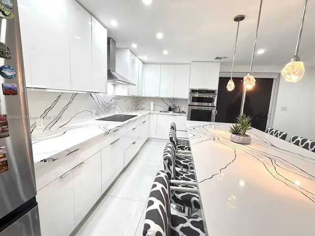 a very nice looking kitchen with a large counter space