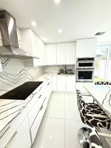 a kitchen with a stove a sink and a microwave