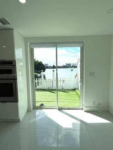 a view of a garden from an empty room