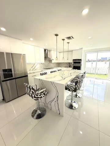 a kitchen with a sink appliances and cabinets