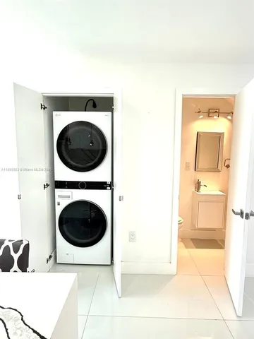 a living room with a sink and a washer dryer