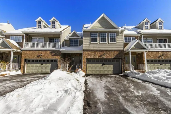a front view of a house with yard and seating space