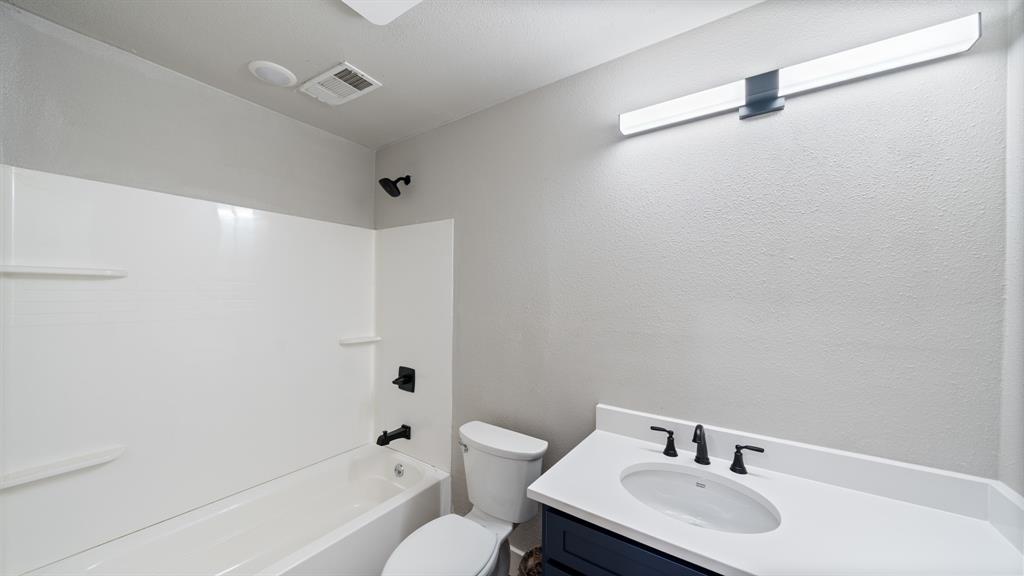 129 King Arthur Road Mabank, TX 75156 - Photo 16 of 33 a bathroom with a sink toilet and shower