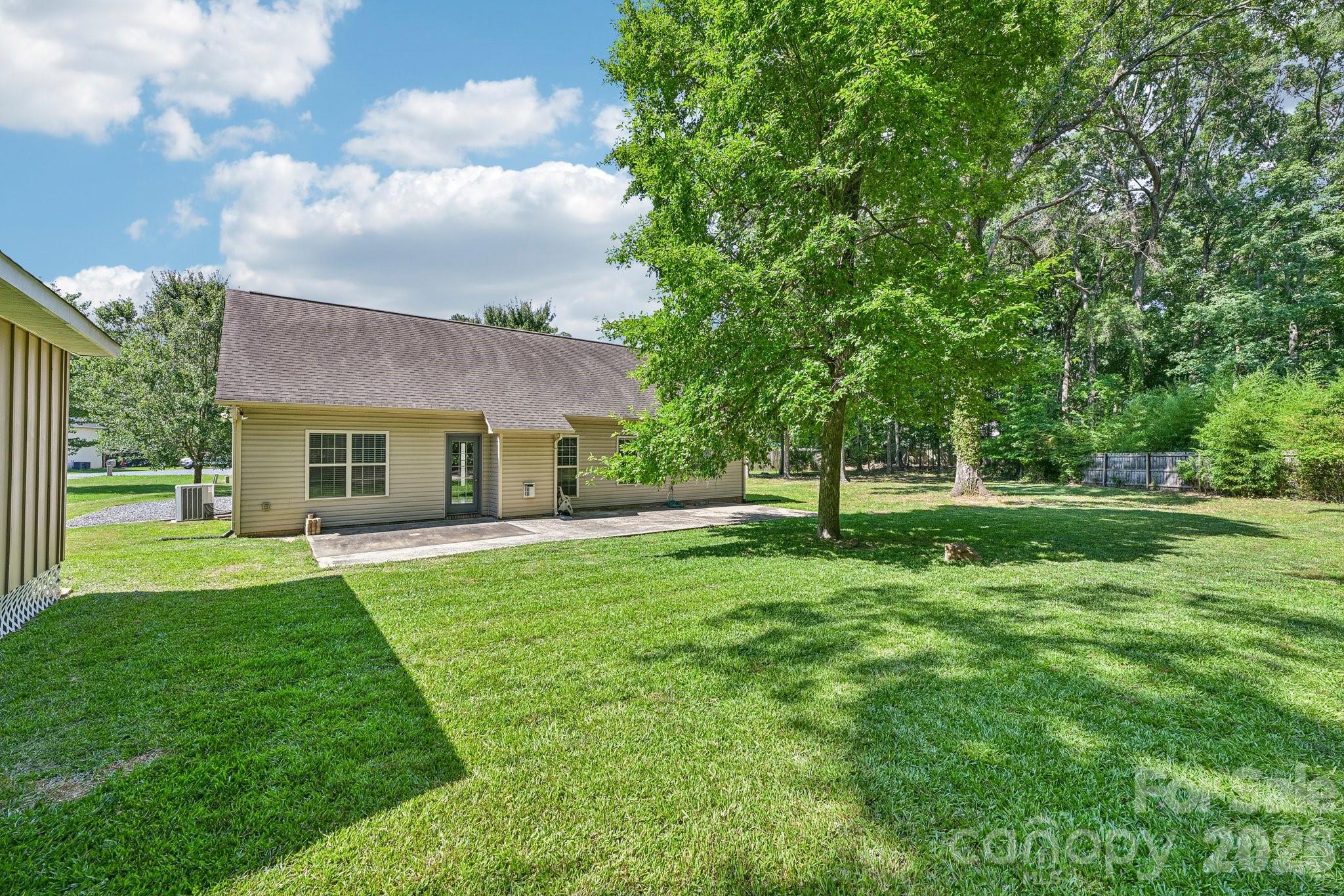 624 Hunley Street Monroe, NC 28112 - Photo 33 of 36 a view of a house with a big yard and large trees