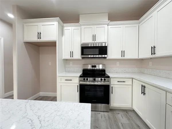 a kitchen with stainless steel appliances granite countertop a stove and a sink