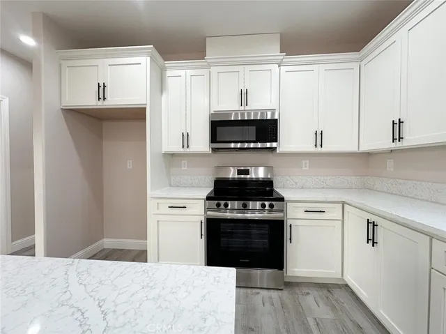 a kitchen with stainless steel appliances granite countertop a stove and a sink