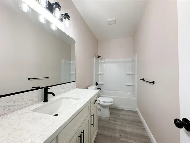 a bathroom with a sink mirror and toilet