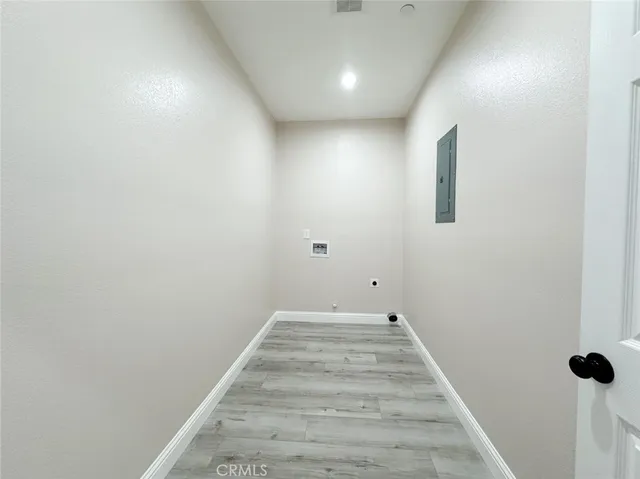 an empty room with windows and closet