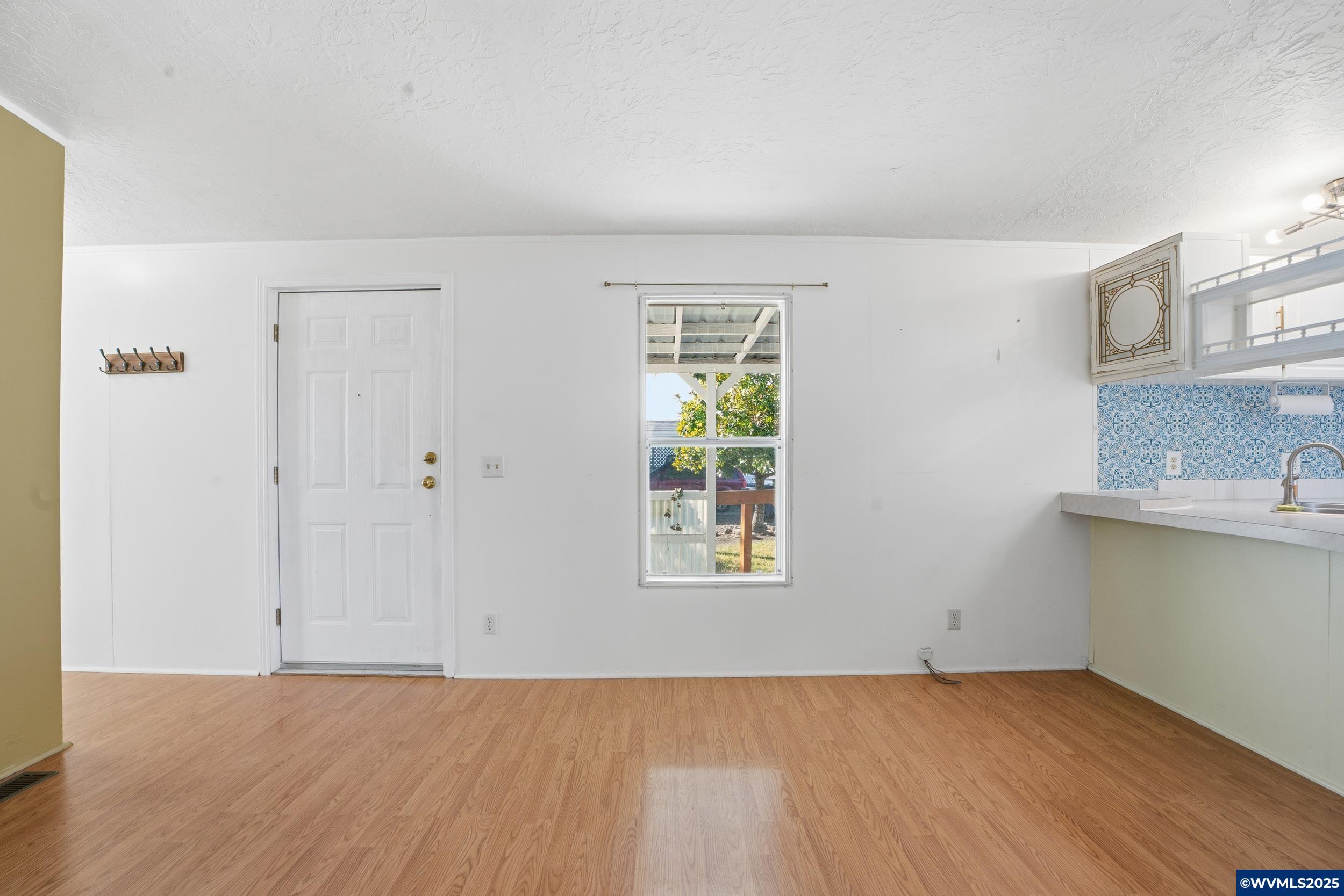 277 Edwards Road, Unit 145 Monmouth, OR 97361 - Photo 2 of 47 an empty room with windows and cabinet