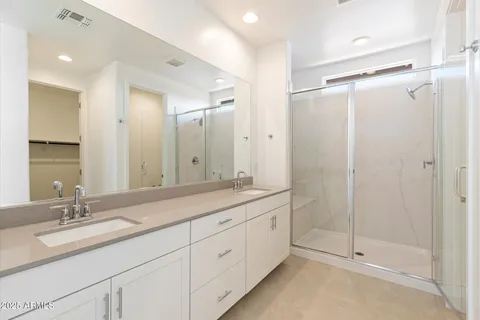 a bedroom with a bed and flat screen tv