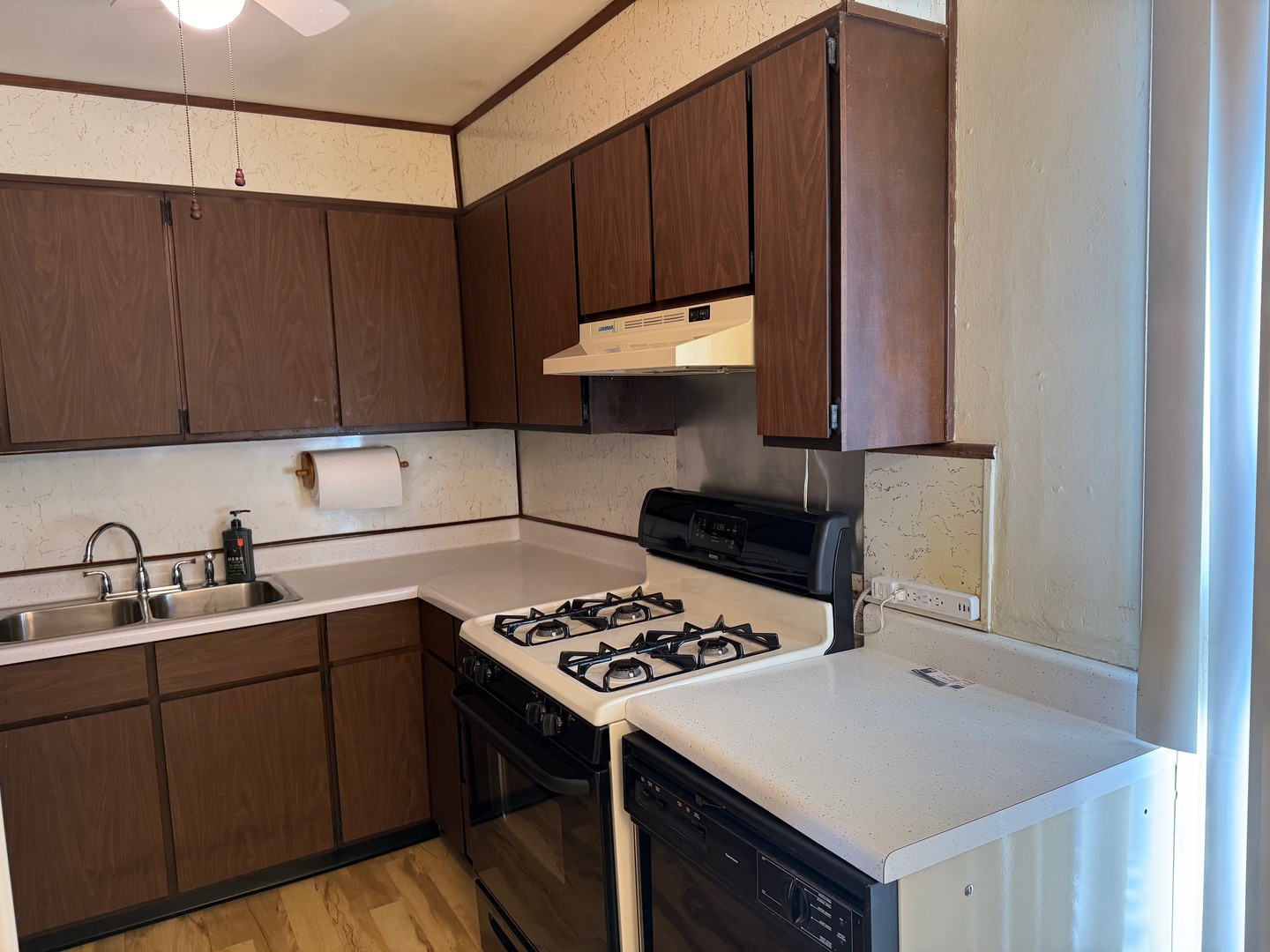 2521 Dakota Road Waukegan, IL 60087 - Photo 12 of 29 a kitchen with a sink cabinets and wooden floor