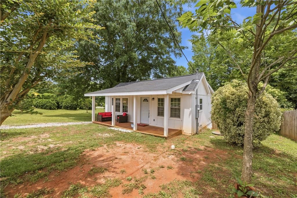 156 Pine Avenue Commerce, GA 30529 - Photo 5 of 35 a view of a house with a yard and large tree