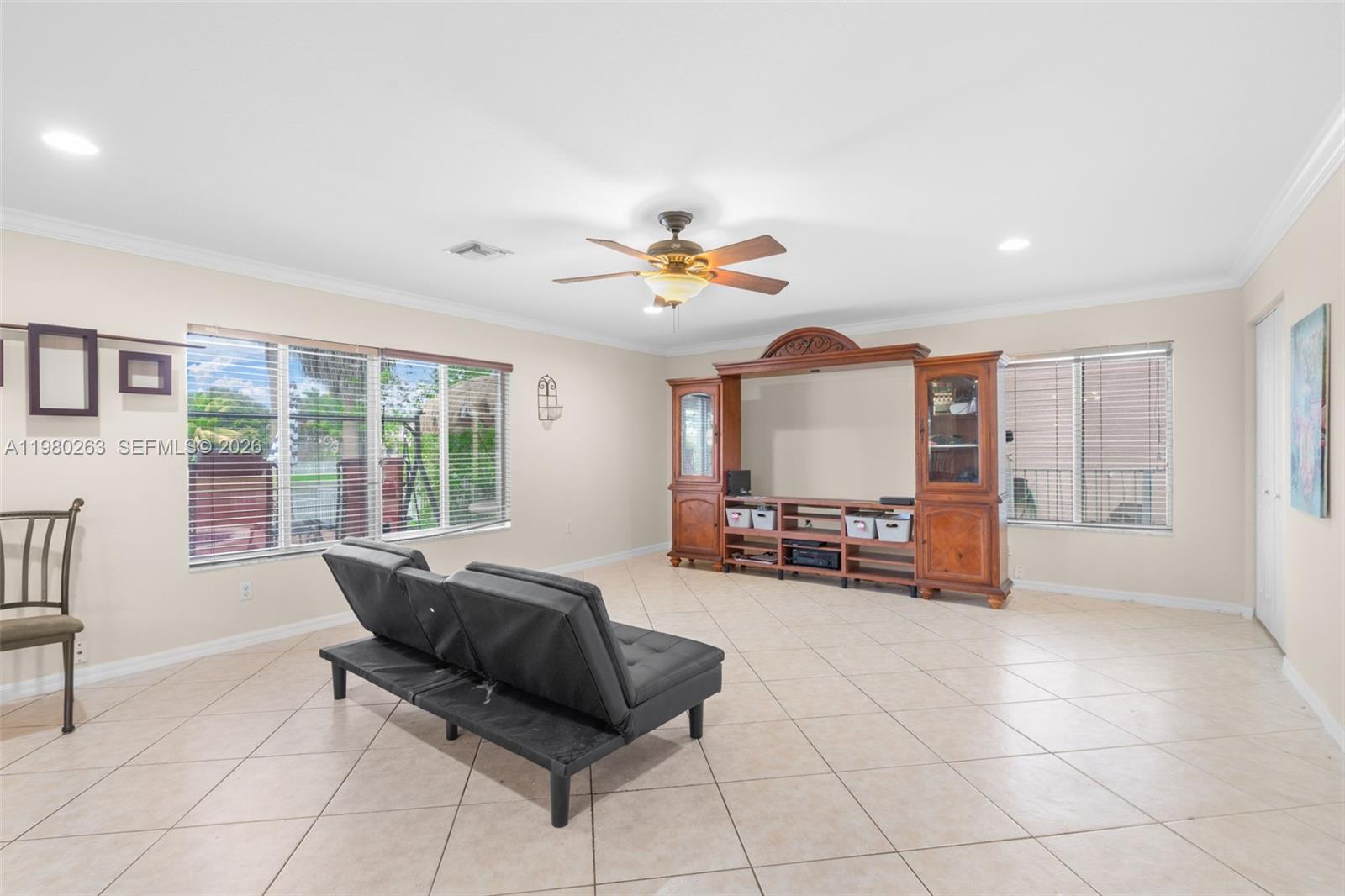 4628 Southwest 129th Avenue Miramar, FL 33027 - Photo 11 of 36 a living room with furniture and a large window