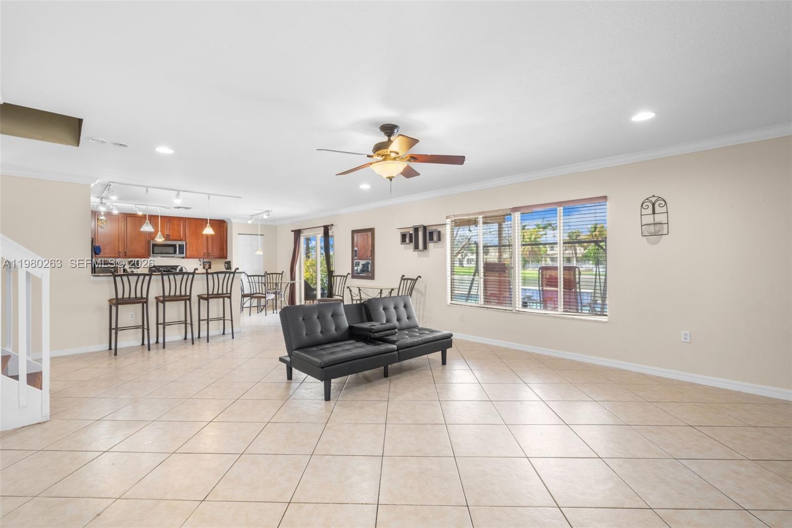 4628 Southwest 129th Avenue Miramar, FL 33027 - Photo 13 of 36 a living room with furniture and a floor to ceiling window