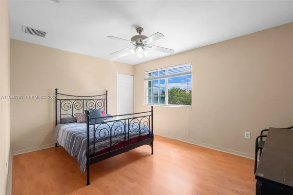 a bedroom with a bed and a window