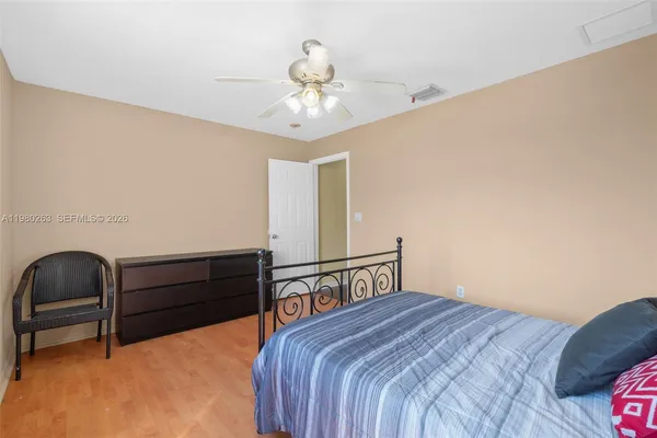 a bedroom with a bed and a ceiling fan
