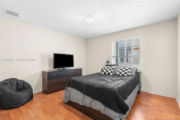 a bedroom with a bed and a television