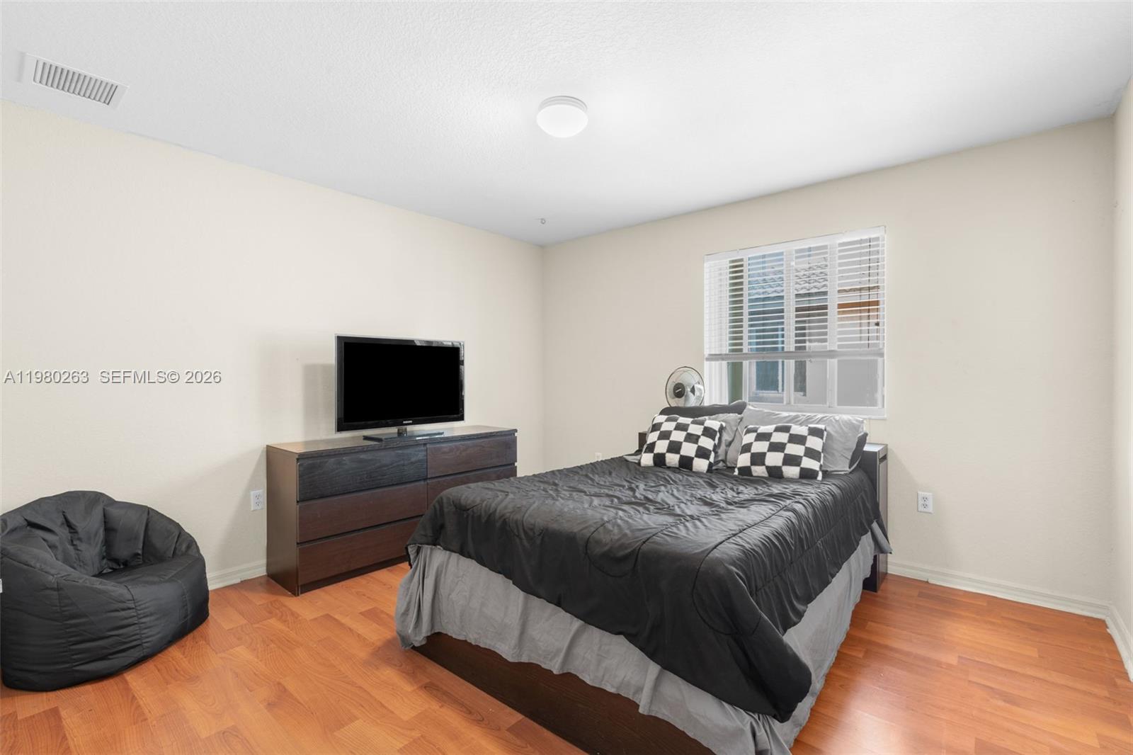 4628 Southwest 129th Avenue Miramar, FL 33027 - Photo 20 of 36 a bedroom with a bed and a television