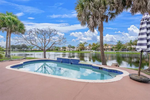 a view of a swimming pool and trees in the background