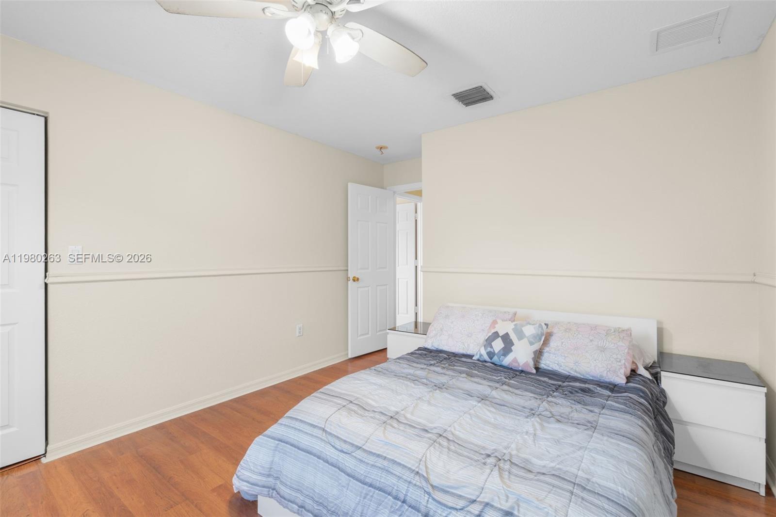 4628 Southwest 129th Avenue Miramar, FL 33027 - Photo 22 of 36 a bedroom with a bed and a chandelier