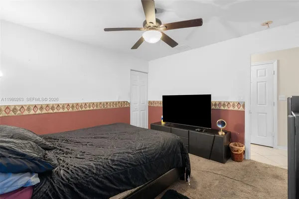 a bedroom with a bed and a flat screen tv