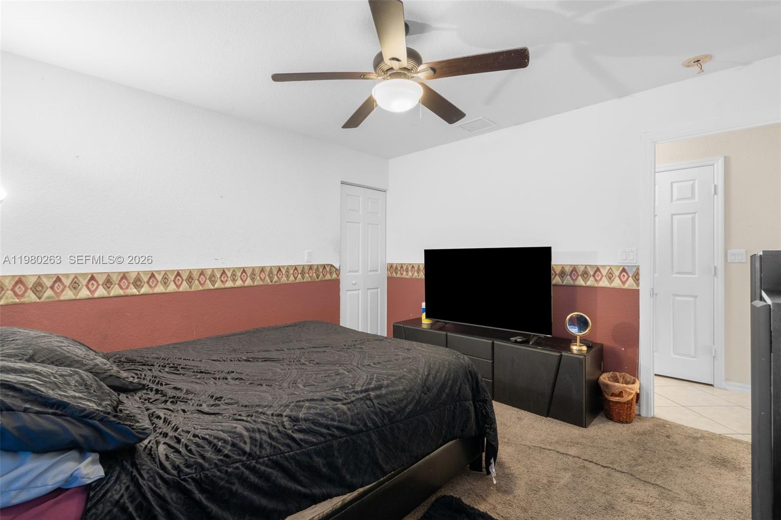 4628 Southwest 129th Avenue Miramar, FL 33027 - Photo 24 of 36 a bedroom with a bed and a flat screen tv