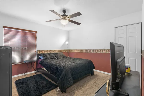 a living room with a bed furniture and a window