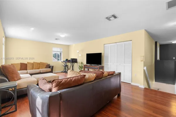 a living room with furniture and a flat screen tv