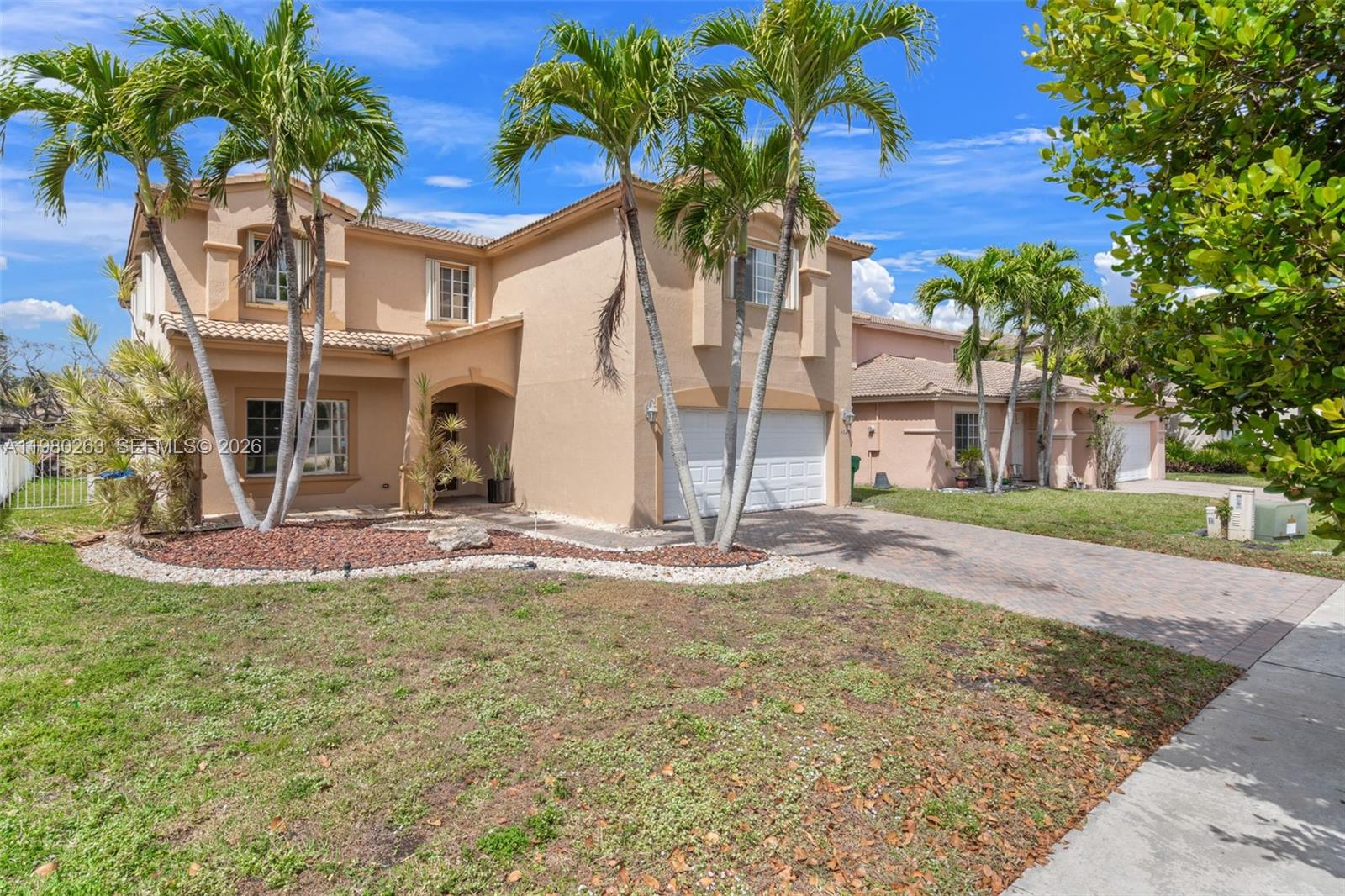4628 Southwest 129th Avenue Miramar, FL 33027 - Photo 3 of 36 a view of a house with a tree and a yard