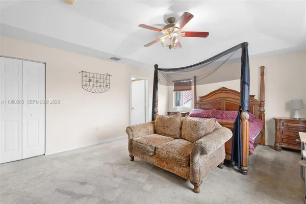 a bedroom with a bed and lamp