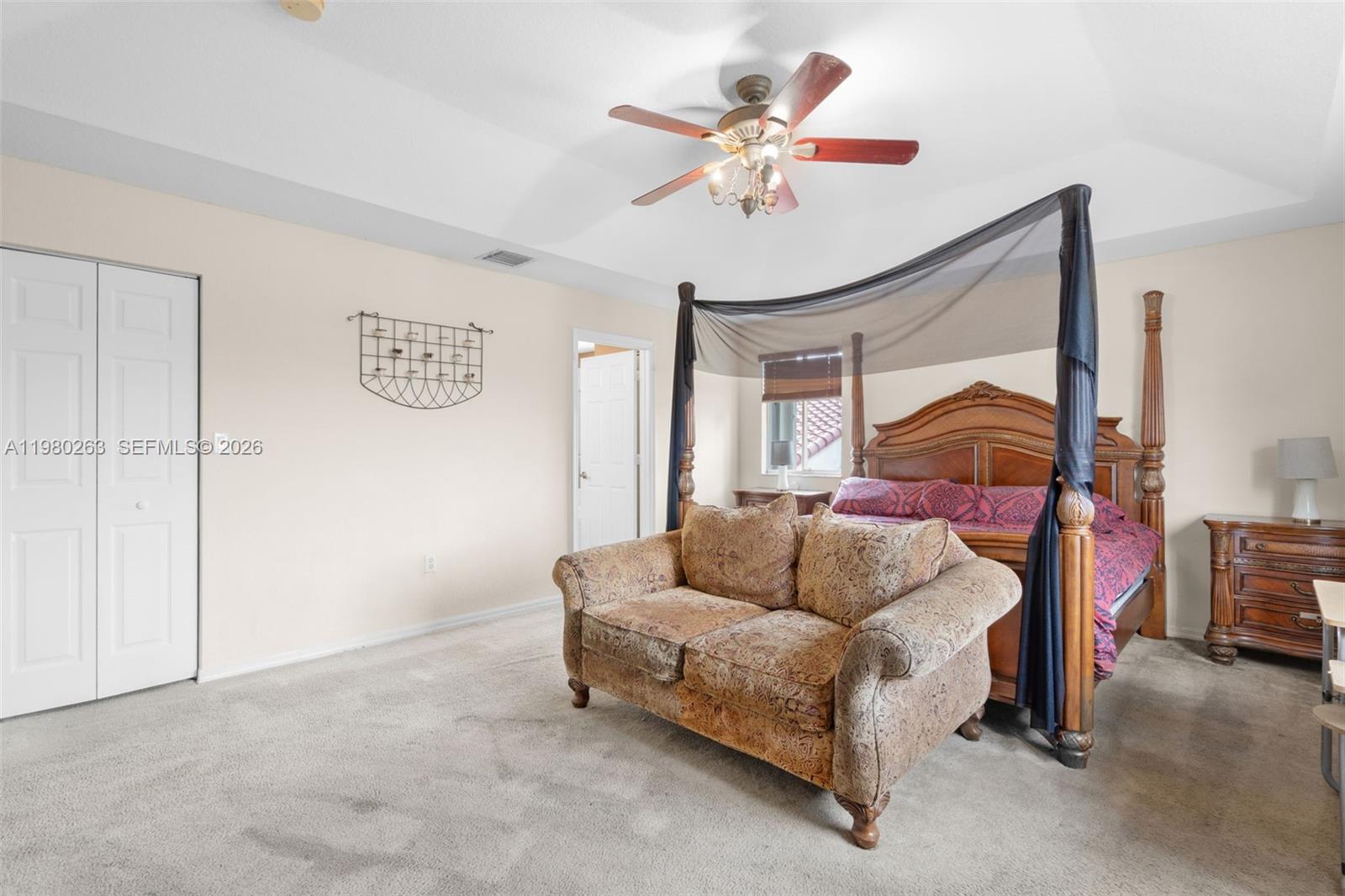 4628 Southwest 129th Avenue Miramar, FL 33027 - Photo 31 of 36 a bedroom with a bed and lamp