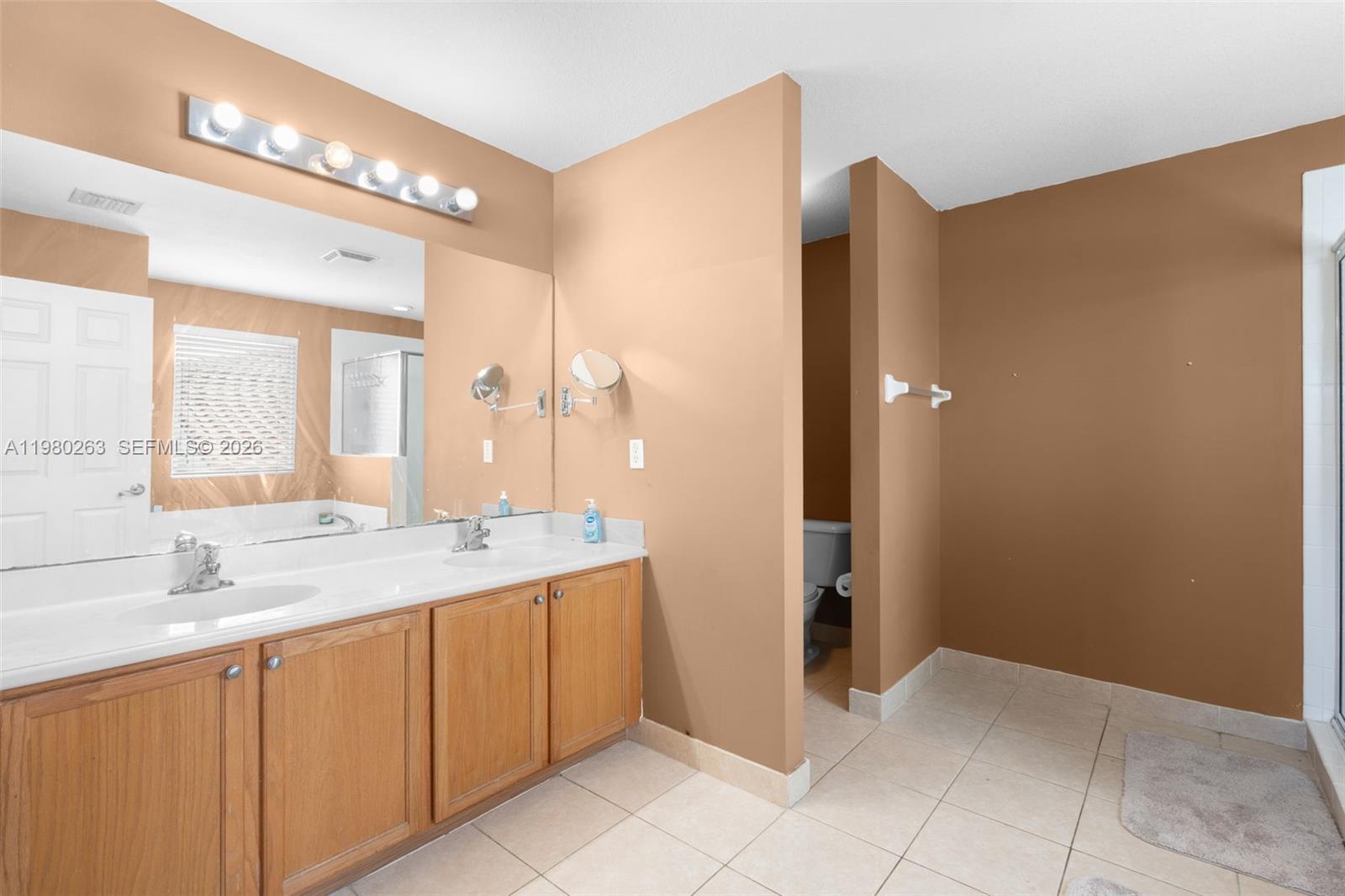 4628 Southwest 129th Avenue Miramar, FL 33027 - Photo 32 of 36 a bathroom with a granite countertop sink and a mirror