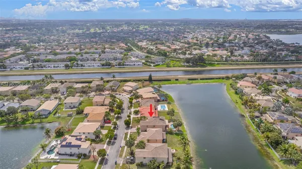 an aerial view of residential building and lake