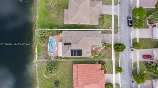 an aerial view of house with swimming pool