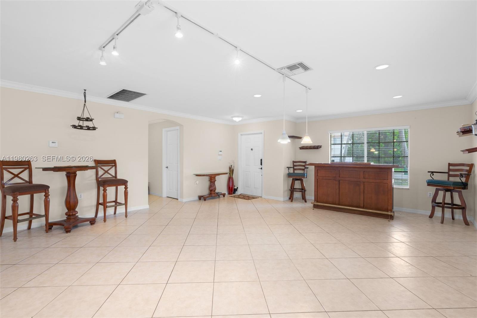 4628 Southwest 129th Avenue Miramar, FL 33027 - Photo 8 of 36 a living room with lots of furniture and a table chair