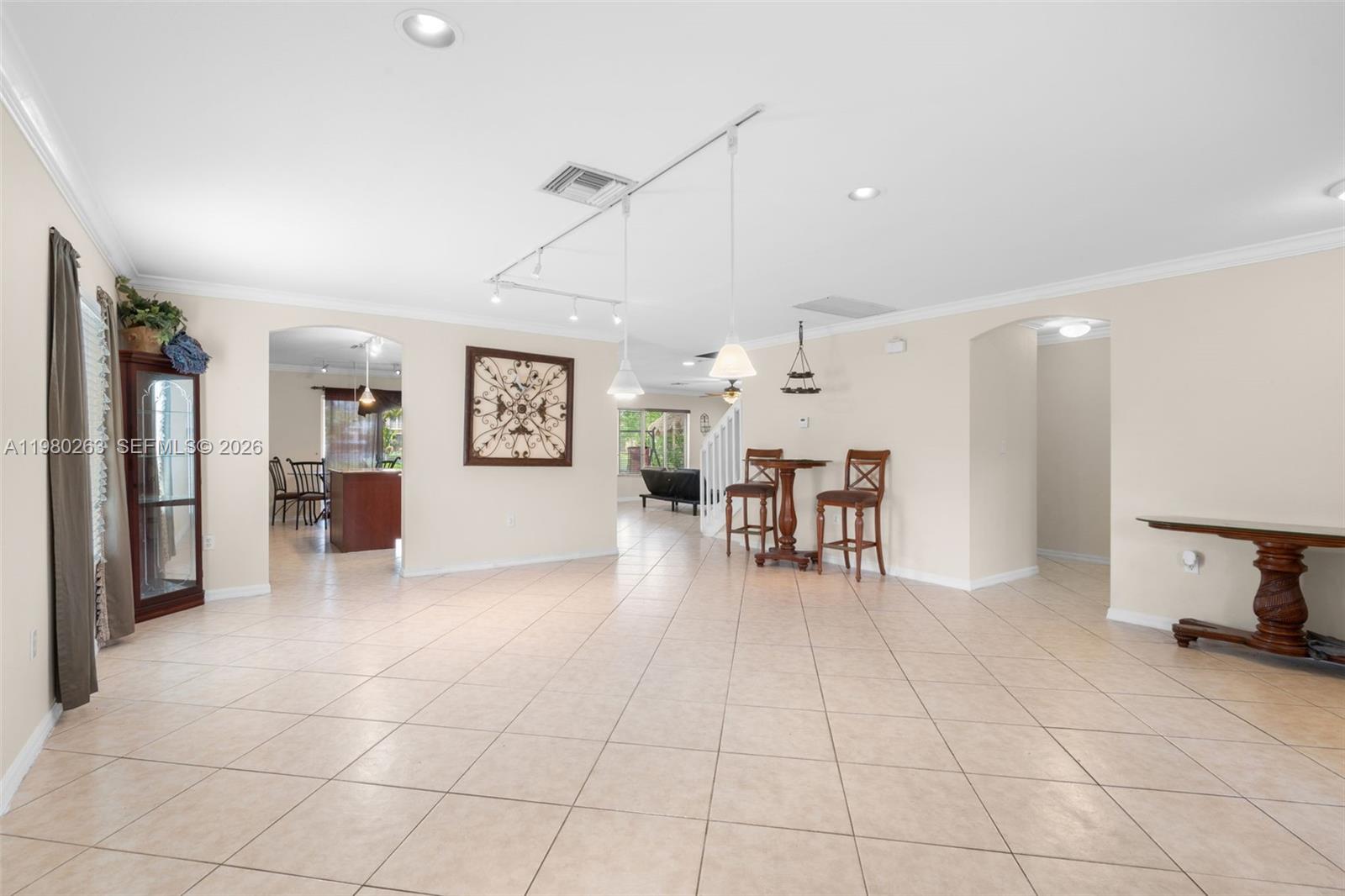 4628 Southwest 129th Avenue Miramar, FL 33027 - Photo 9 of 36 a view of a livingroom with furniture and a refrigerator