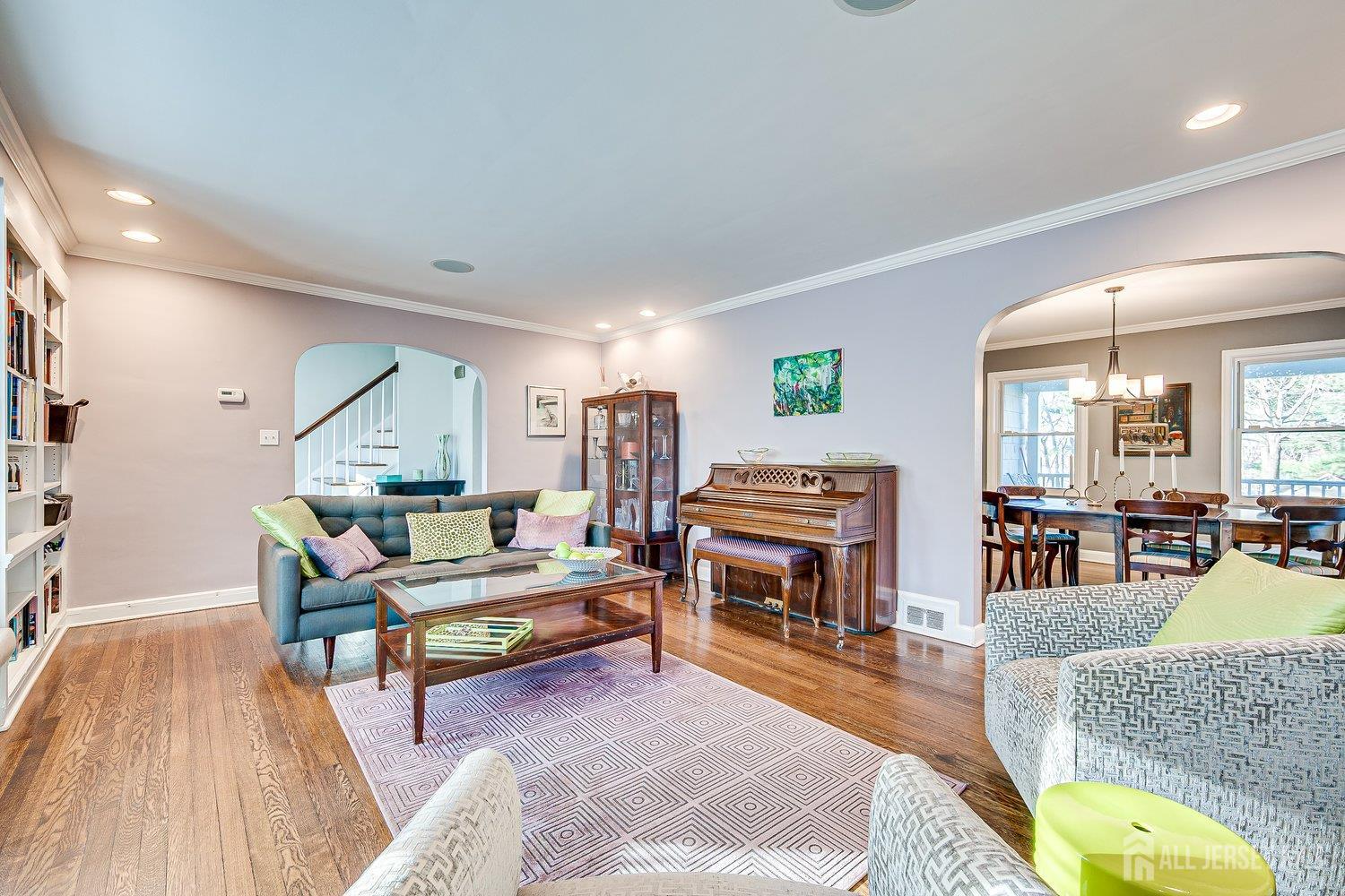 62 Spring Street Metuchen, NJ 08840 - Photo 15 of 47 a living room with furniture a piano and a bookshelf