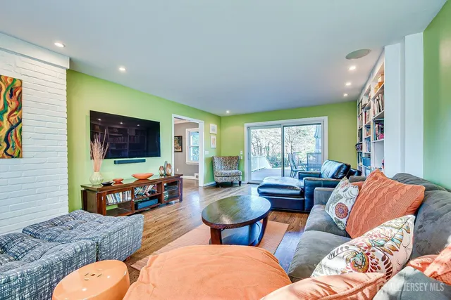 a kitchen with a dining table chairs wooden floor and appliances