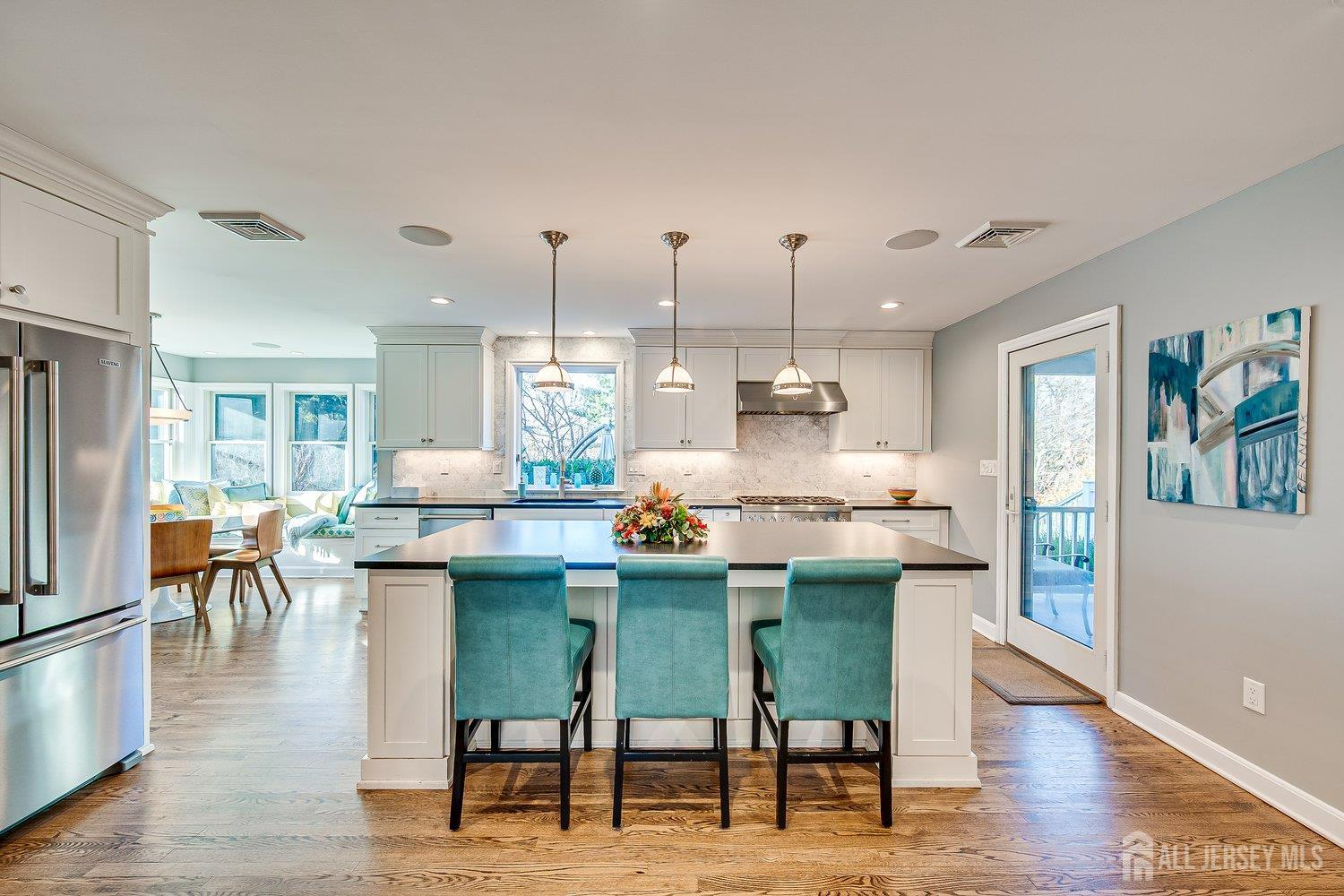 62 Spring Street Metuchen, NJ 08840 - Photo 19 of 47 a dining room with furniture a chandelier and wooden floor