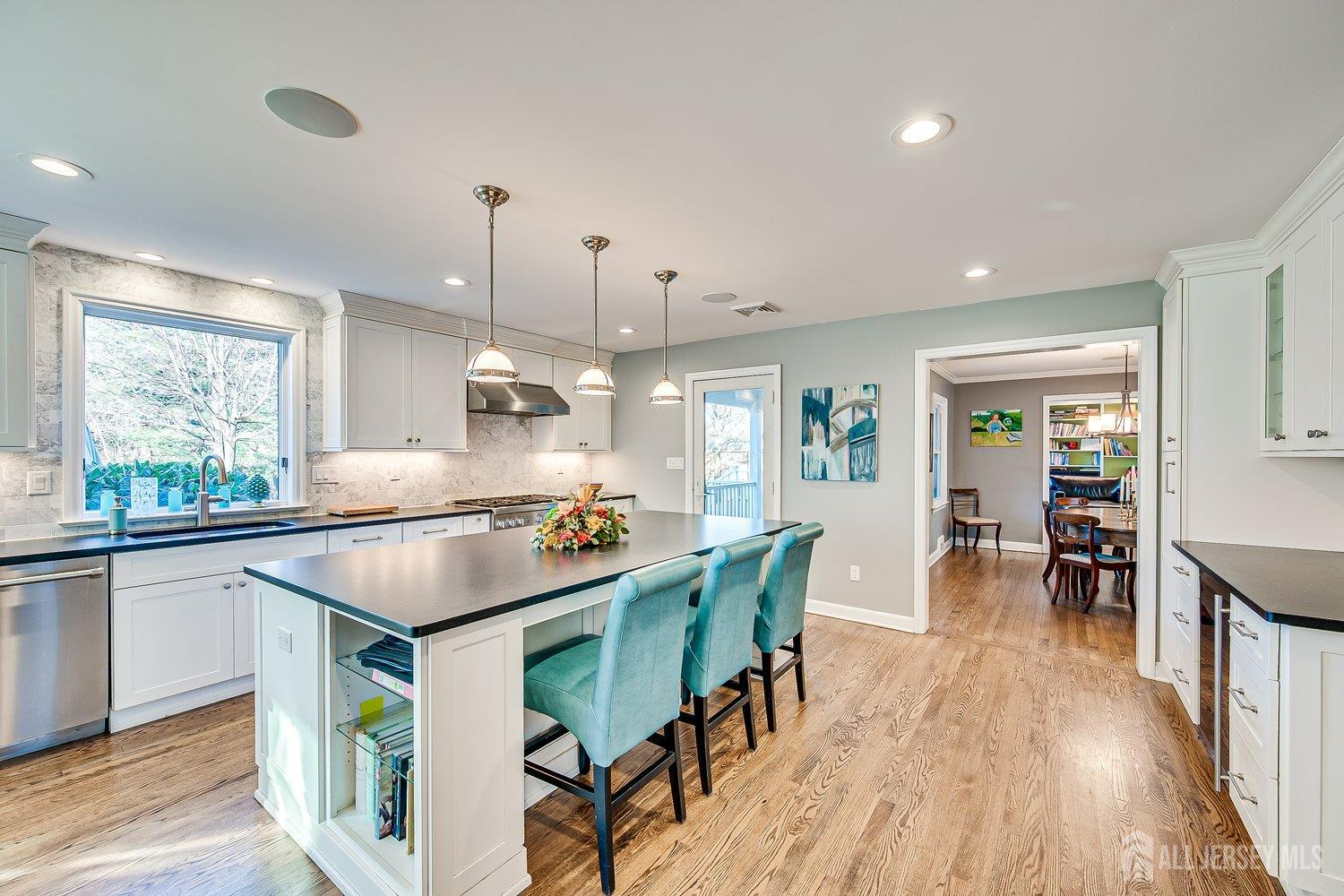 62 Spring Street Metuchen, NJ 08840 - Photo 20 of 47 a kitchen with a dining table chairs wooden floor and appliances