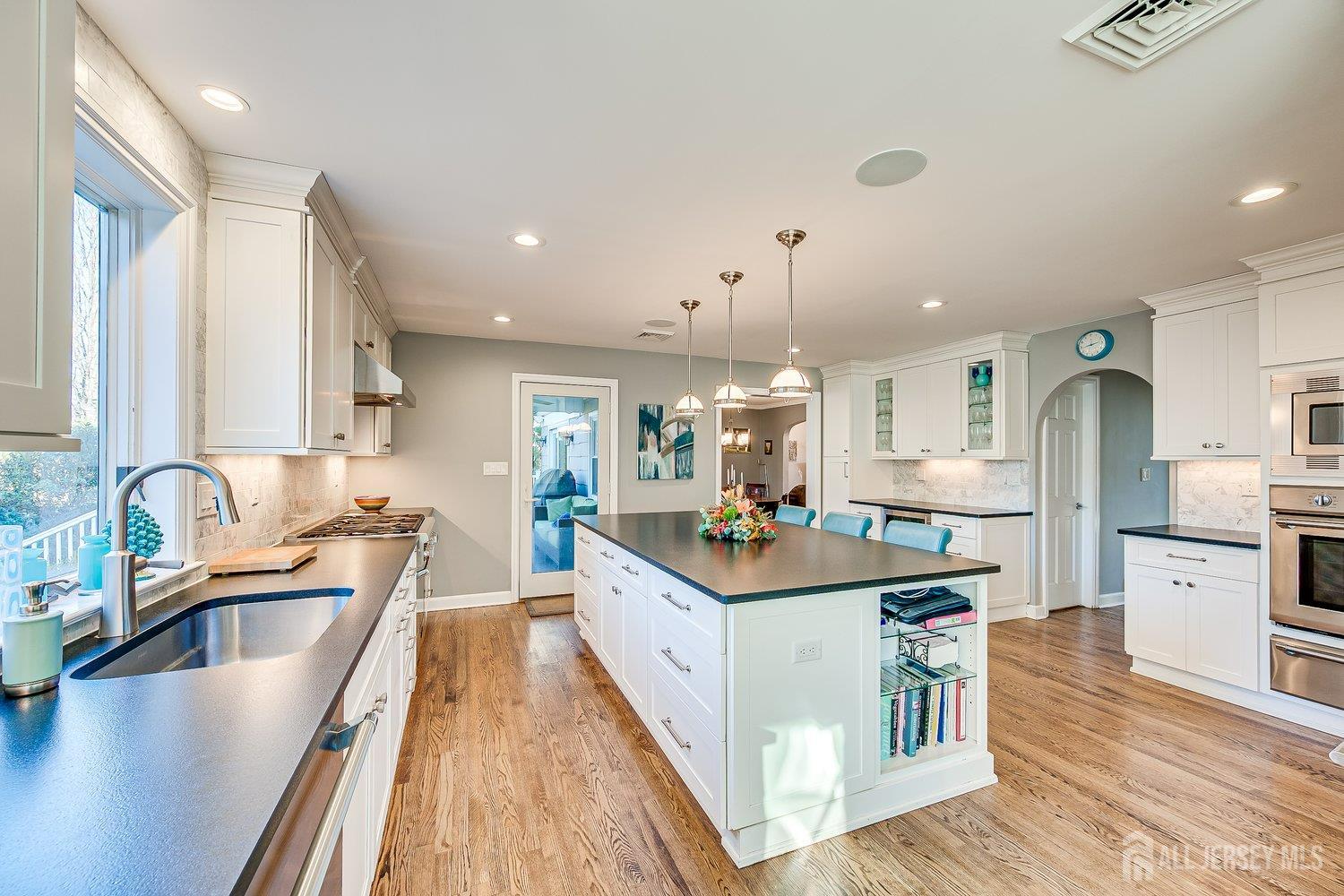 62 Spring Street Metuchen, NJ 08840 - Photo 21 of 47 a kitchen with stainless steel appliances granite countertop a sink stove and refrigerator