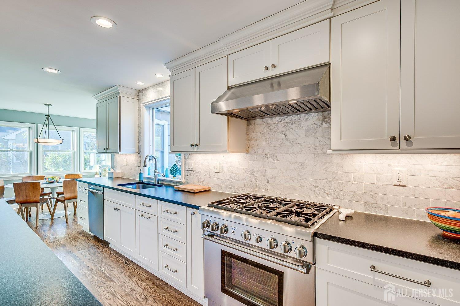 62 Spring Street Metuchen, NJ 08840 - Photo 23 of 47 a kitchen with stainless steel appliances a stove a sink and white cabinets