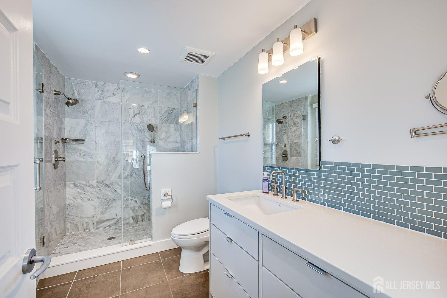 62 Spring Street Metuchen, NJ 08840 - Photo 28 of 47 a bathroom with a sink a toilet and shower