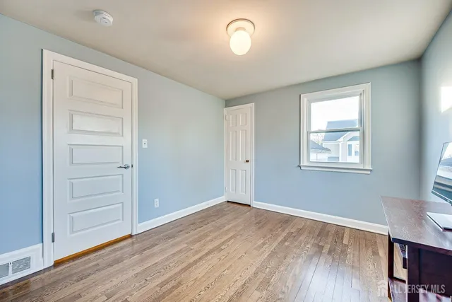 a bed room with furniture and a wooden floor